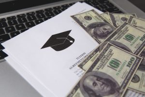 Money with a computer and scholarship award
