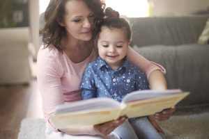 Women reading a book with a child